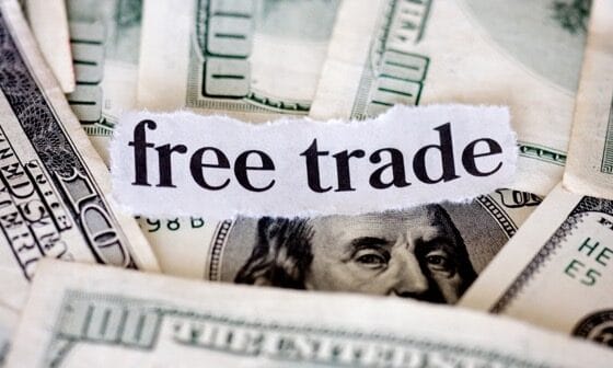 Free Trade symbolizing the economic burden shifted onto American workers and industries.